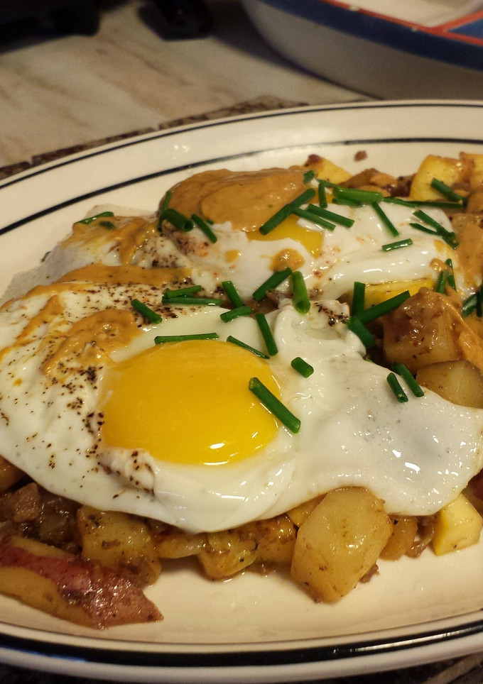 A picture of Chorizo Hash with Over Easy Eggs.