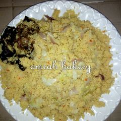 A picture of Cuscus with fried meat.