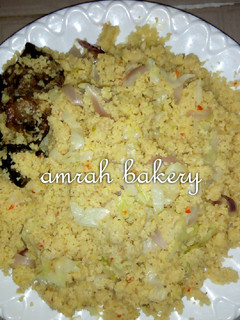 A picture of Cuscus with fried meat.
