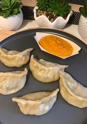 A picture of Chicken Momos with Momos Chutney.