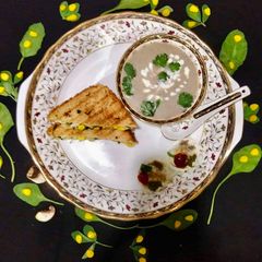 A picture of Cream of Mushroom Soup With Spinach-Methi Egg Sandwich.