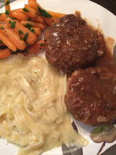 A picture of Mini Breaded Meatloafs In Gravy.
