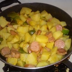 A picture of Fried potatoes and turkey sausage.