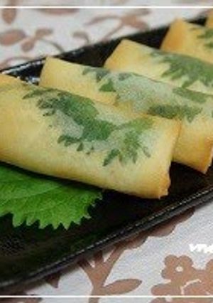 A picture of Spring Rolls Filled With Chicken Tenders and Cheese, Accented with Shiso.