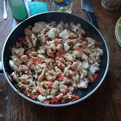A picture of Fried chicken fillet with bell pepper and parsley.