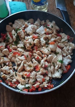 A picture of Fried chicken fillet with bell pepper and parsley.