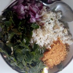 A picture of Rice and beans with moringa leaves.