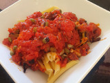 Pasta in spicy chorizo tomato sauce with capers