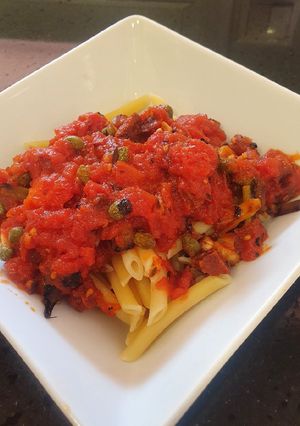 A picture of Pasta in spicy chorizo tomato sauce with capers.