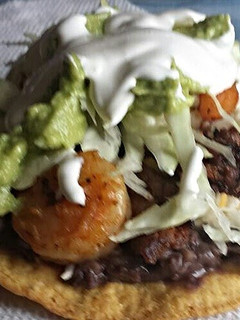 A picture of Shrimp and beef tostada.
