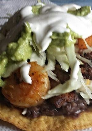 A picture of Shrimp and beef tostada.