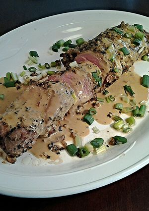 A picture of Sesame / Peanut Crusted Pork Tenderloin with Wasabi Cream Sauce.