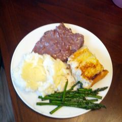 A picture of Venison steaks with red wine blue cheese sauce.