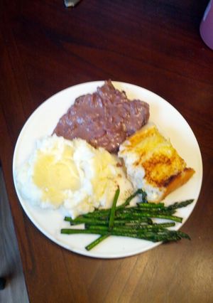 A picture of Venison steaks with red wine blue cheese sauce.
