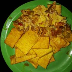 A picture of Fried yam and egg with palmoil.