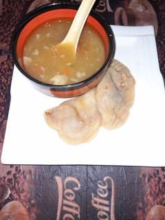 A picture of Chicken dumplings with hot and sour soup.