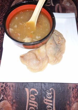 A picture of Chicken dumplings with hot and sour soup.