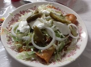 Una foto de Enchiladas de flor de jamaica guisada a lo ranchero