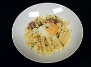 A picture of penne pasta with egg