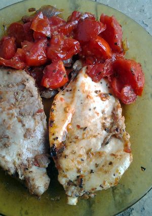 A picture of Chicken breasts with thyme and vegetables.