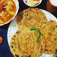 A picture of Lachchha paratha with rasadar aloo.