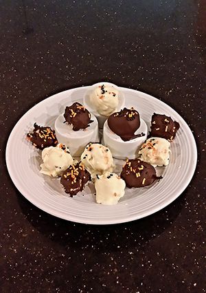 A picture of Cheesecake Balls, Covered in Dark Or White Chocolate.