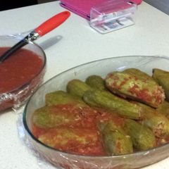 A picture of kusa bi banadoora (stuffed zucchini cooked in tomato).