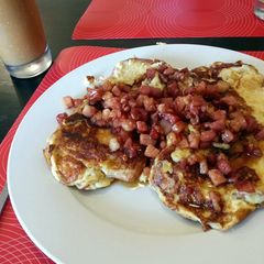 A picture of soft french toast with maple syrup bacon.