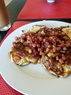 A picture of soft french toast with maple syrup bacon.