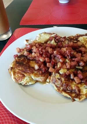 A picture of soft french toast with maple syrup bacon.