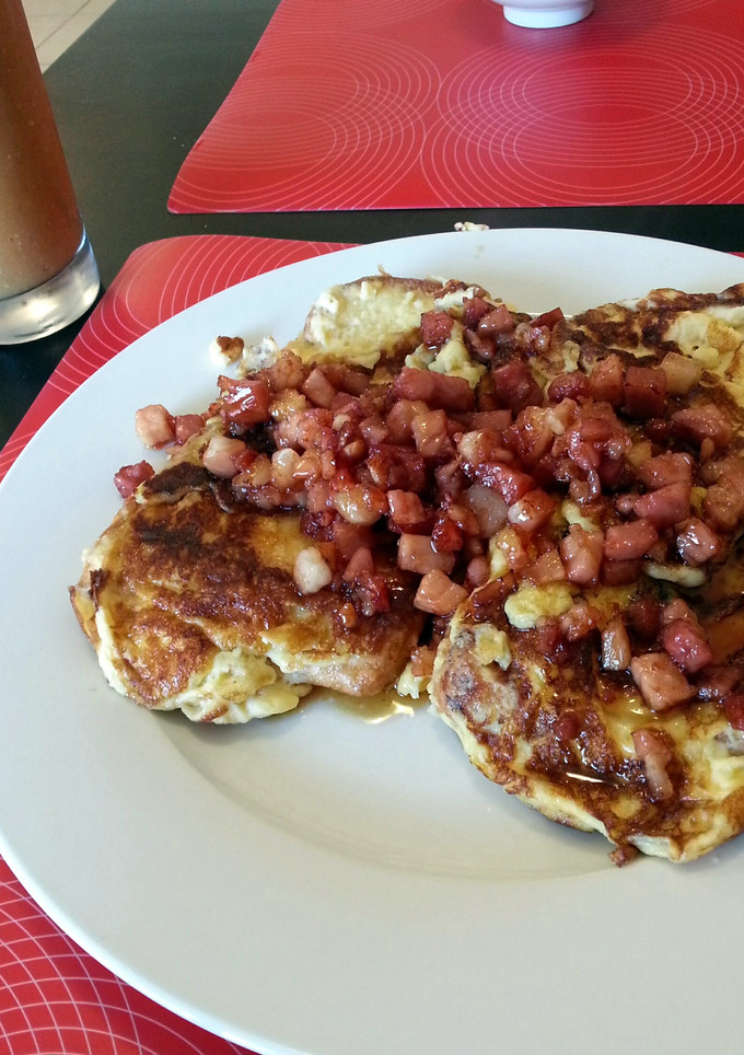 A picture of soft french toast with maple syrup bacon.