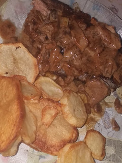 Una foto de Corte americano con salsa de champiñón y papas fritas