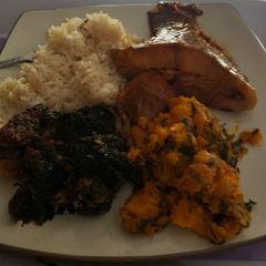A picture of Boiled rice with vegetables and porriage yam with fish.