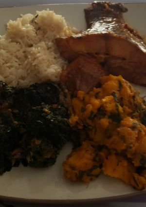 A picture of Boiled rice with vegetables and porriage yam with fish.