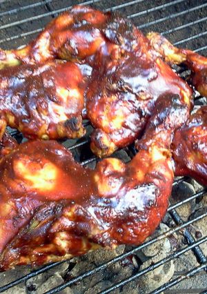 A picture of grilled chicken quarters.