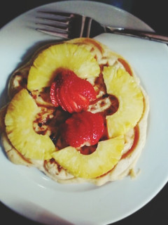 A picture of Waffles with dried fruits and cinnamon.