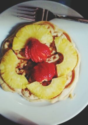 A picture of Waffles with dried fruits and cinnamon.