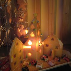 A picture of A Lit Up Decorative Cookie House For Christmas.