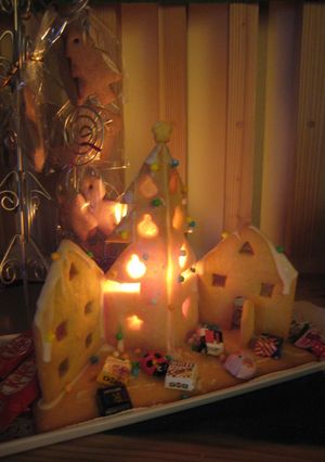 A picture of A Lit Up Decorative Cookie House For Christmas.