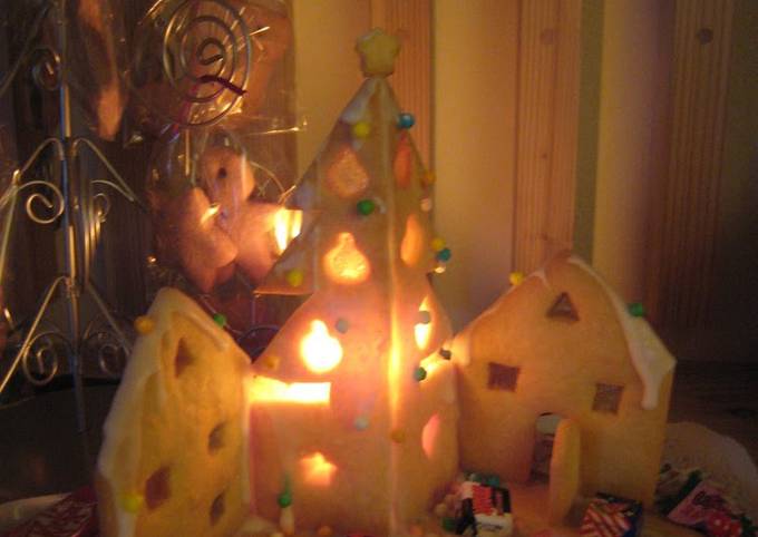 A Lit Up Decorative Cookie House For Christmas