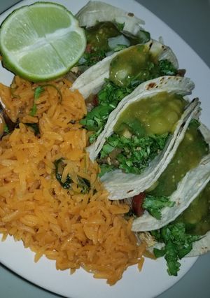 A picture of Fajita & chicken tacos, rice.