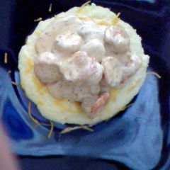 A picture of Southern Style Grits Topped with creamy Cajun Shrimp.