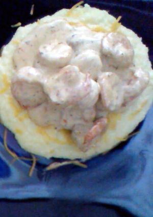 A picture of Southern Style Grits Topped with creamy Cajun Shrimp.