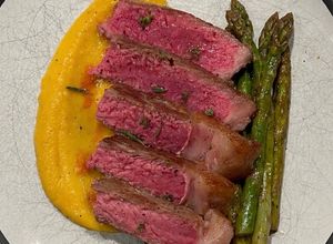 Foto di Bistecca di manzo con purea di zucca e asparagi al burro
