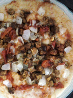 A picture of microwave chicken tikka pizza.