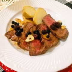 A picture of Beef Steak with Berry Sauce.