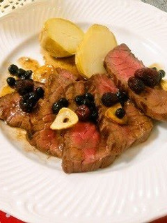 A picture of Beef Steak with Berry Sauce.