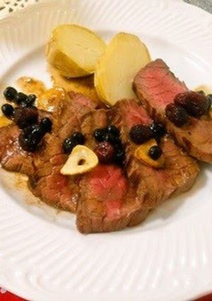 A picture of Beef Steak with Berry Sauce.