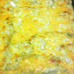 A picture of sour cream and cheese enchiladas.