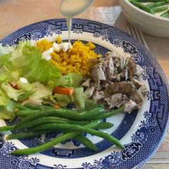 A picture of Chicken Shawarma w/ White Sauce and Fluffy Yellow Rice.